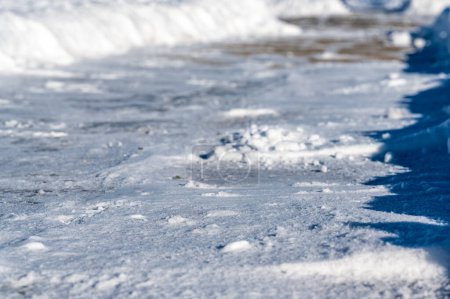 Photo for Selective focus on cut bank of a snow blown sidewalk section with path continuing. . High quality photo - Royalty Free Image