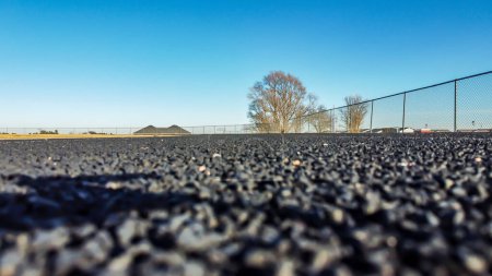 Ground level photo of a rubberized track surface. . High quality photo