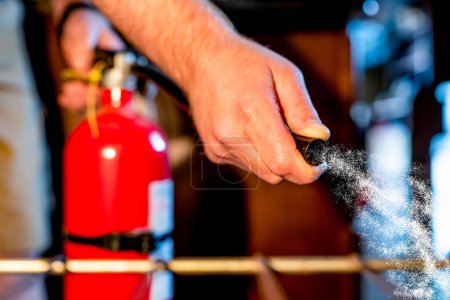 View from inside an oven with selective focus on a extinguisher being aimed at the fire. . High quality photo