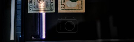 Using a copy machine to print fake currency. . High quality photo