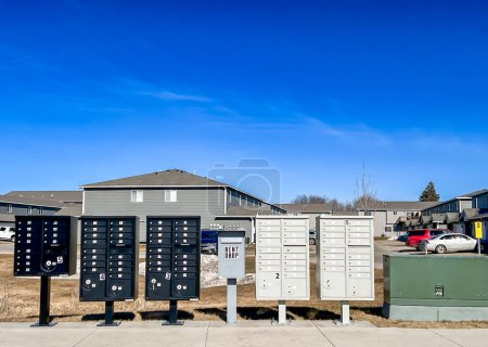 A whimsical photograph capturing a delightful row of mailboxes, proudly standing on the side of the road, creating a visual harmony of colors and forms.