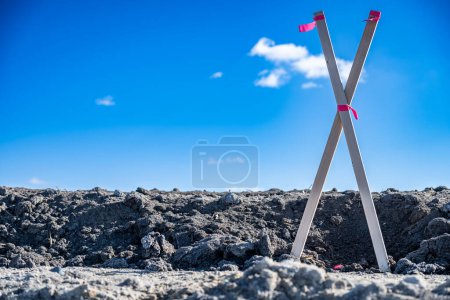 Selective focus on survey stake and flag at a construction site. High quality photo