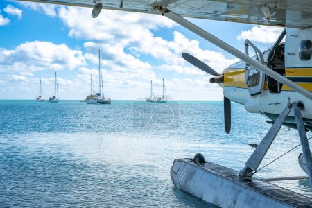Seaplane floating in the water at Dry Tortugas National Park with distant boats. . High quality photo
