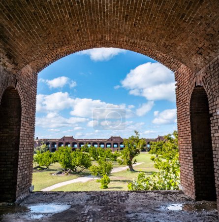 View through an open archway in Fort Jefferson on Dry Tortugas National Park with a the open courtyard a parade ground in the distance. High quality photo