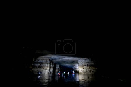 Kayaking a abandoned silica mine that is flooded with water. High quality photo