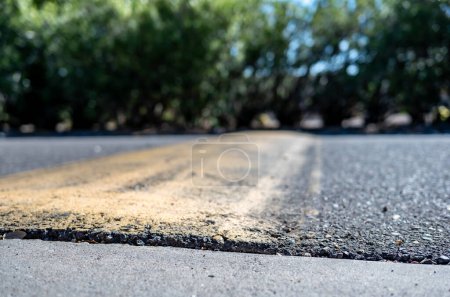 Selective focus on area in front of a asphalt speed bump . High quality photo