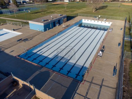 Drone view of an empty and drained winterized swimming pool . High quality photo