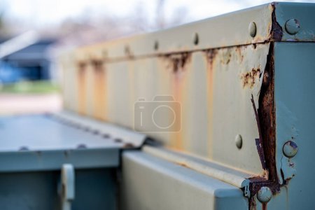 Rusted and peeling paint on an electrical transformer exposed to the elements. . High quality photo