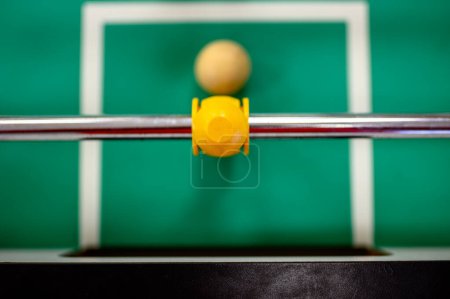 top view on a foosball goalie blocking the ball insider the box. High quality photo