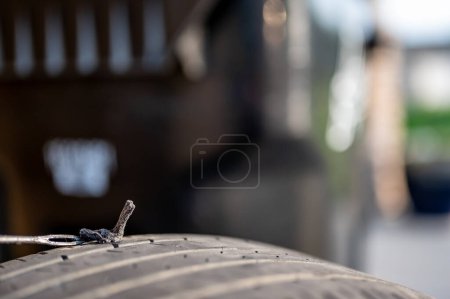Photo for Repair plug being inserted to patch a nail tire puncture. High quality photo - Royalty Free Image
