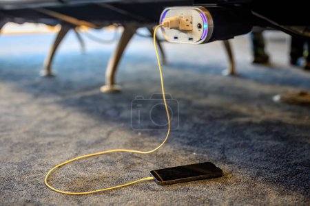 Selective focus on airport terminal phone charging outlet station. High quality photo
