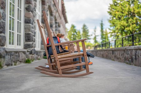 rocking chairs on the outdoor walkway of the lodge overlooking Crater Lake National Park. High quality photo