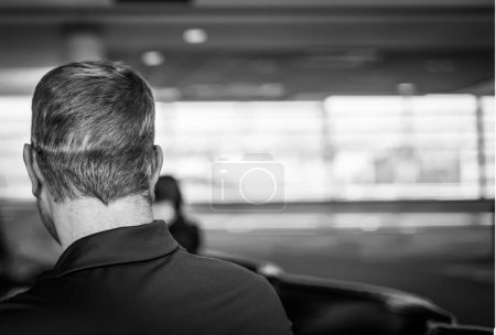 Selective focus on the back of an adult male with hat-hair caused by wearing a baseball cap. High quality photo
