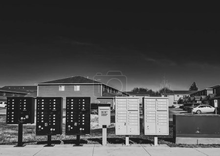 A captivating black and white photo featuring a row of beautifully weathered mailboxes, evoking a sense of nostalgia and anticipation.