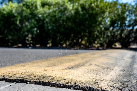 Selective focus on area in front of a asphalt speed bump . High quality photo