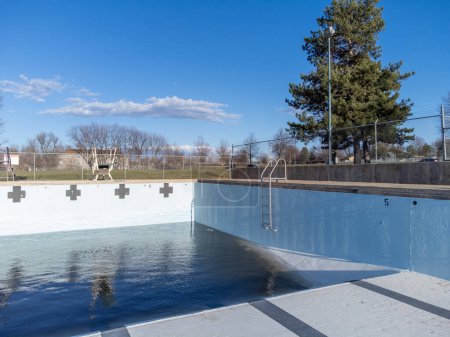 inside an empty and drained winterized swimming pool . High quality photo