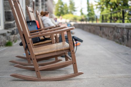 rocking chairs on the outdoor walkway of the lodge overlooking Crater Lake National Park. High quality photo