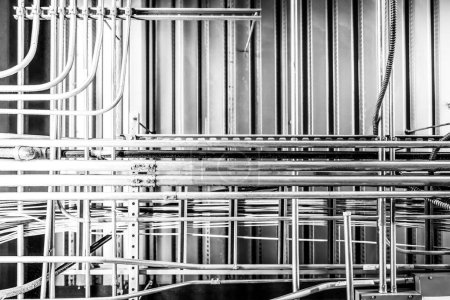 Looking up into an industrial ceiling with complex crisscross of utilities. . High quality photo