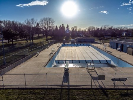 Drone view of an empty and drained winterized swimming pool . High quality photo
