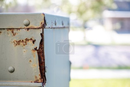 Rusted and peeling paint on an electrical transformer exposed to the elements. . High quality photo