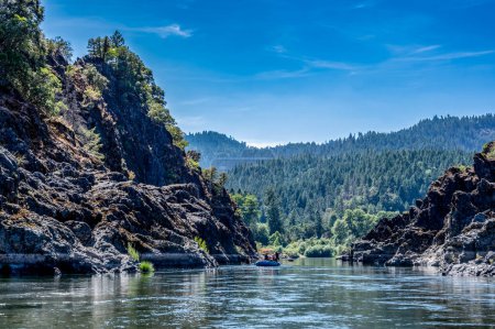 Photo for Wild and scenic Rogue River in Southern Oregon with a distant rafter floating. . High quality photo - Royalty Free Image