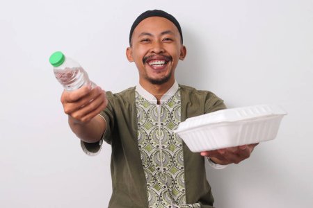 Ein indonesischer muslimischer Mann in Koko und Peci hält ein Tablett mit Mineralwasser und Takjil in der Hand, um es denjenigen anzubieten, die in Not sind, um ihr Ramadan-Fasten zu brechen. Isoliert auf weißem Hintergrund