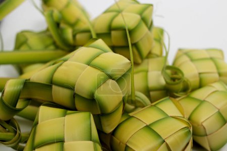 Ketupat pouch woven from palm leaves (close-up, white background)