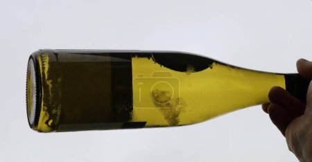 Photo for White wine bottle with tartrate crystals or wine diamonds in the wine - Royalty Free Image