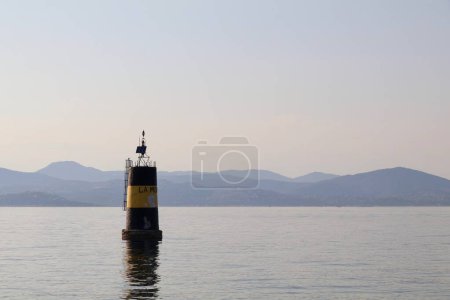 Photo for Large black and yellow buoy in the Mediterranean - text on the buoy is the name of the beach: la Moutte - Royalty Free Image