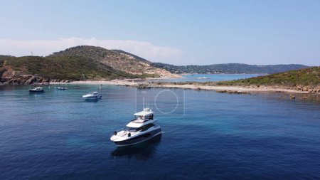 Photo for Aerial view of private yachts and small boats anchored in a small bay in the Mediterranean sea - Royalty Free Image