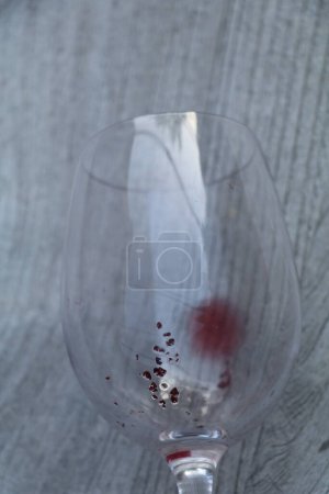 Photo for Wine diamonds or tartrate crystals at the bottom of an empty glass of red wine - Royalty Free Image
