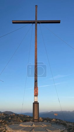 Photo for Large summit cross marking the top of the mountain with a clear blue sky in the background - Royalty Free Image