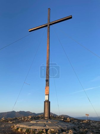 Photo for Large summit cross marking the top of the mountain with a clear blue sky in the background - Royalty Free Image