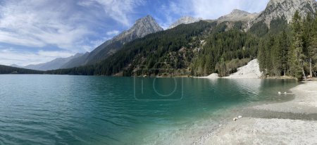 panoramic view of Lake Antholz with a pebble beach and the surrounding mountains