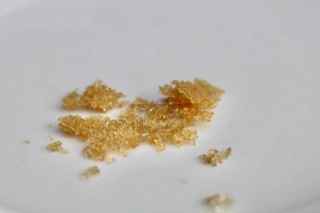 gold colored white wine crystals or wine diamonds on a white background
