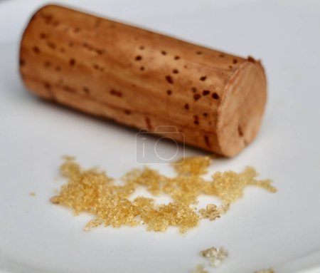 white wine crystals  and a wine cork on a white background