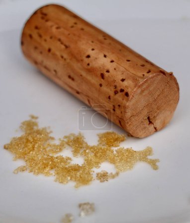 white wine crystals  and a wine cork on a white background