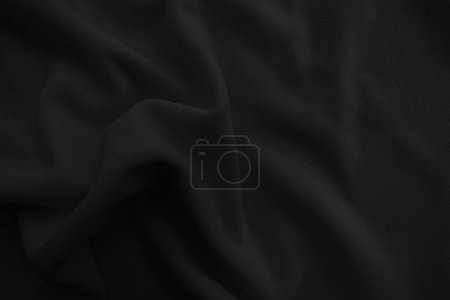 Téléchargez les photos : Nappe ondulée noire abstraite. Fond en tissu sombre. - en image libre de droit