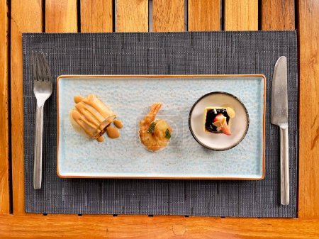 Afternoon tea snack, cocktail, shrimp tempura with wasabi cream sauce, spicy chicken roll and blueberry tarts dessert