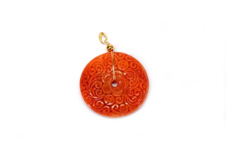Jadeite Jade pendant isolated on white background. Natural red color Burmese Jadeite Jade Bi Disc with beautiful flowers carving pattern.