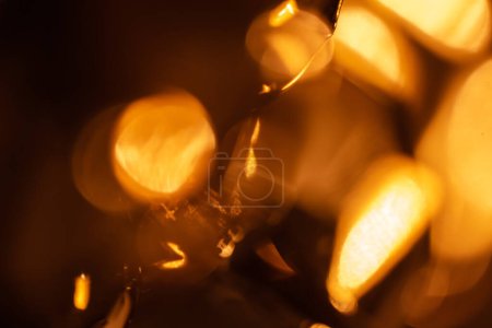 Foto de Colorido tiro de bokeh guirnalda brillante con bombillas en habitación oscura - Imagen libre de derechos
