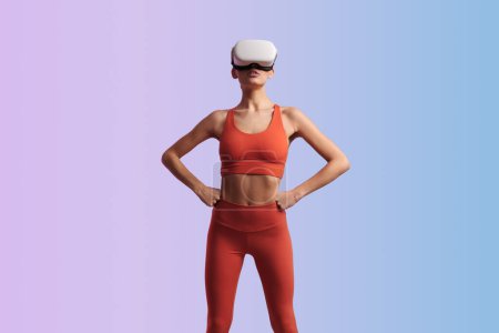 Photo for Muscular anonymous female athlete in sportswear in modern VR headset ready for virtual fitness workout against violet and blue background - Royalty Free Image