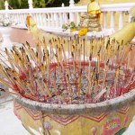 The incense sticks and candle worship the Buddha image statue.