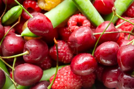 Photo for Cherries, raspberries and green peas. Background photo of berries. Summer berries together - cherries, green peas and raspberries. - Royalty Free Image