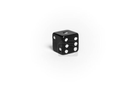 Téléchargez les photos : A playful cube on a white background. The game dice is rotated with the number 6. On the white is a dice cube. A black cube on a white background. - en image libre de droit