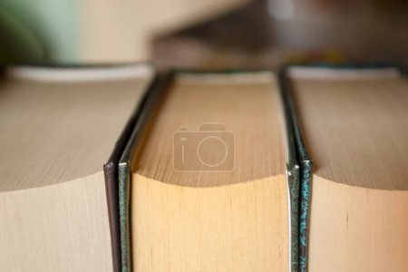 Photo for Book stubs up close. Closed macro workbooks. Books stand tightly with each other on the shelf. - Royalty Free Image