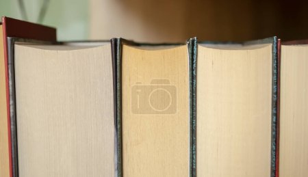 Photo for Book stubs up close. Books stand tightly with each other on the shelf. Closed macro workbooks. - Royalty Free Image