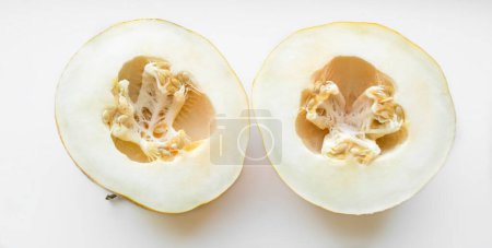 Photo for Light melon with seeds. Two halves of melon on a white background. - Royalty Free Image