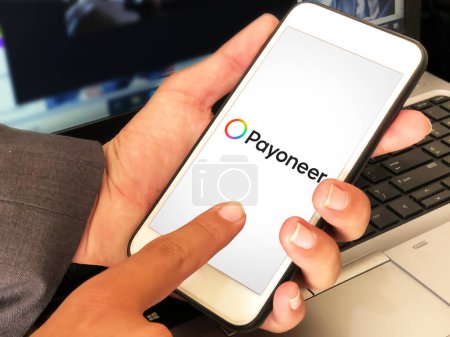 Photo for Person touching payment method mobile applicaiton payoneer editorial background. Payment and financial system concept backdrop - Royalty Free Image