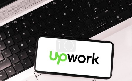 Photo for Upwork mobile application concept background with laptop in the background. Editorial freelancing backdrop - Royalty Free Image